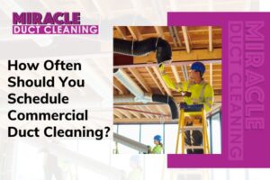 Technician performing commercial duct cleaning in office