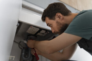 A man professionally cleaning dryer vent in Brampton